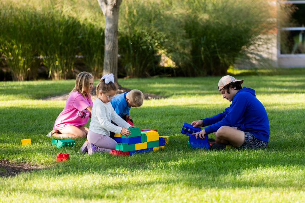 Children playing with toys on Kirkhof Lawn.